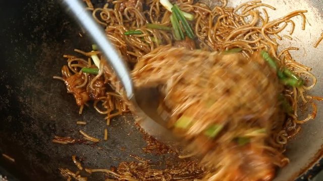 Frying noodles with  pork and vegetables  in pan
