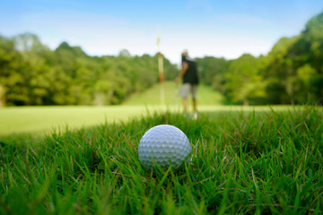 Golf ball on green in beautiful golf course at sunset background. Golf ball on green in golf course at Thailand