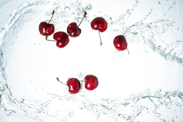 Fototapeta na wymiar Red cherries water splash