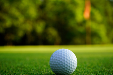 Golf ball on green in beautiful golf course at sunset background. Golf ball on green in golf course at Thailand
