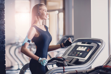 Happy women jogging on a treadmill for health.