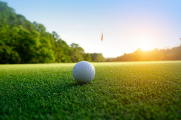 Golf ball on green in beautiful golf course at sunset background. Golf ball on green in golf course...