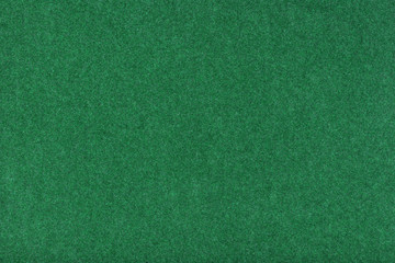 Light green matt suede fabric closeup. Velvet texture of felt.