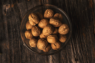 walnuts in a bowl on wooden table
