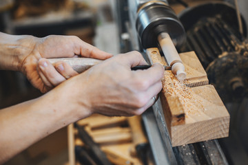 The carpenter works with a tree