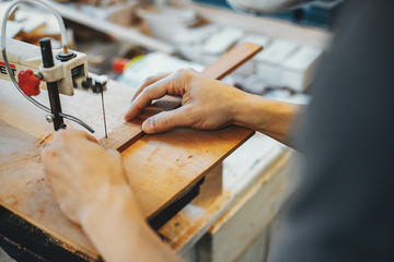 The carpenter works with a tree