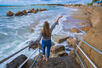 Girl on the sea. Waves  and blue water. Travel photo 2018, december. Landscape and nature.