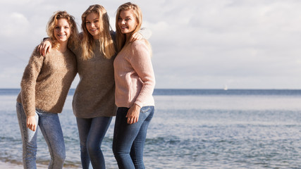 Three fashionable sister on the beach