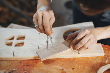 The carpenter works with a tree
