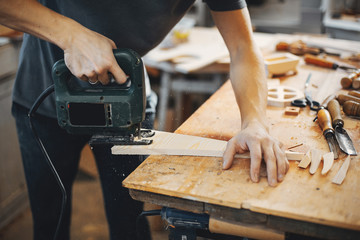 The carpenter works with a tree