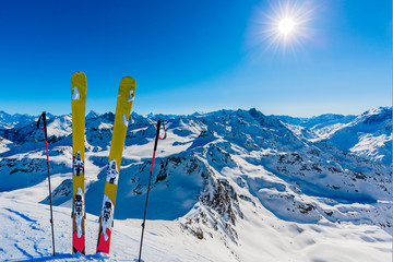 Ski in winter season, mountains and ski touring backcountry equipments on the top of snowy mountains in sunny day, Verbier Switzerland.