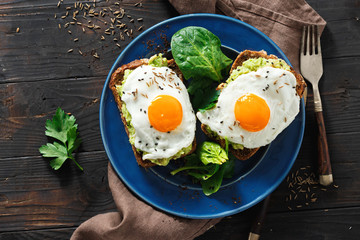Top view healthy avocado toasts breakfast lunch avocado fried eggs