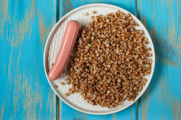 buckwheat, Bowl of tasty porridge on wooden table (breakfast), top view. copy space