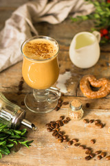 coffee with milk - cappuccino (cup of coffee) arabica in a transparent cup on a wooden table. Top view. copy space