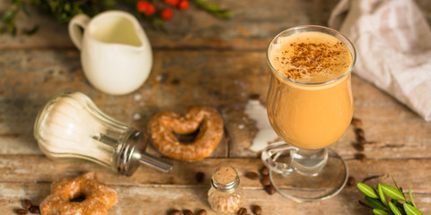 coffee with milk - cappuccino (cup of coffee) arabica in a transparent cup on a wooden table. Top view. copy space