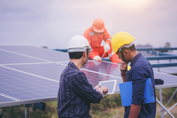 Electrical and instrument technician discuss to plan to maintenance electric system at solar panel...