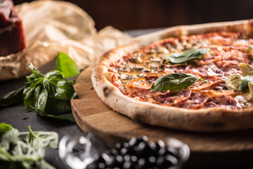 Pizza Quatro Stagioni four seasons traditional italian meal from artichokes mushrooms tomatoes ham prosciutto parmesan cheese and basil