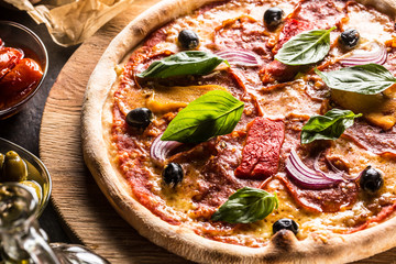 Pizza diavolo traditional italian meal from spicy salami peperoni chili onion olives and basil