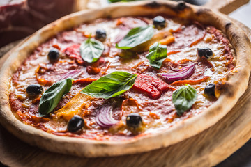 Pizza diavolo traditional italian meal from spicy salami peperoni chili onion olives and basil