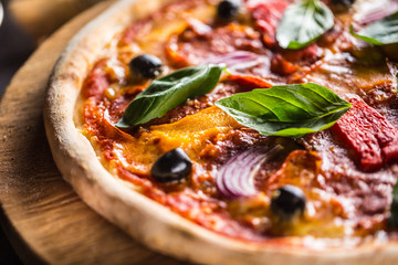 Pizza diavolo traditional italian meal from spicy salami peperoni chili onion olives and basil