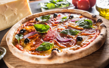 Pizza diavolo traditional italian meal from spicy salami peperoni chili onion olives and basil