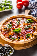 Pizza diavolo traditional italian meal from spicy salami peperoni chili onion olives and basil