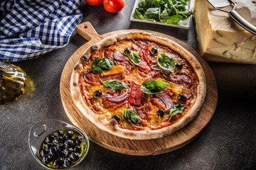 Pizza diavolo traditional italian meal from spicy salami peperoni chili onion olives and basil