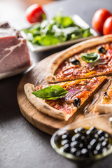 Pizza diavolo traditional italian meal from spicy salami peperoni chili onion olives and basil