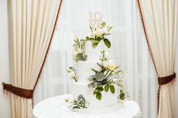  White wedding cake with flowers.  The word Love with heart.