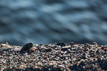 Background with gravel and blurred water