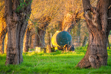And old moveable water tank somewhere in the Belgian country side, seen here during sunet