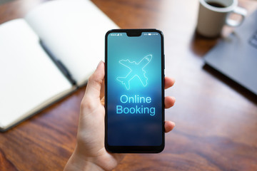 Flight booking application on mobile phone screen. Business and technology concept.