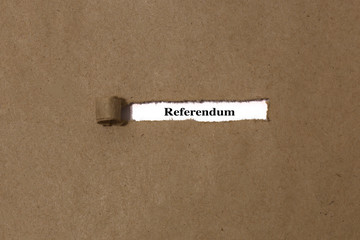 Ripped brown manilla envelope revealing the word referendum on white paper.  UK Brexit deal concept