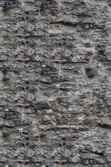 Fragment of old gray brick stone wall background