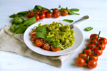 spinach tagliatelle with cherry tomatoes. proper diet.