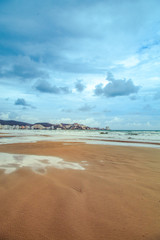 Sandy beach after rain in a resort town of Cullera, near Valencia in Spain.