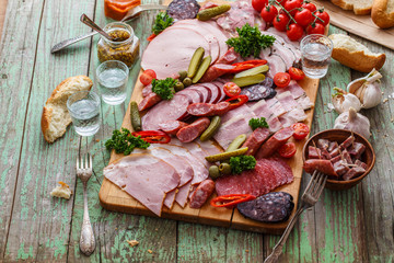 Charcuterie board with sausages and smoked meat. Top view.