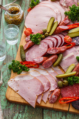 Charcuterie board with sausages and smoked meat. Top view.