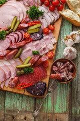 Charcuterie board with sausages and smoked meat. Top view.