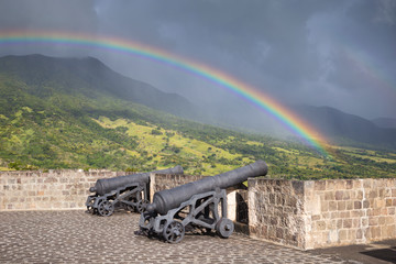 Rainbow above a cannons at Brimstone Hill Fortress on Saint Kitts. West Indies