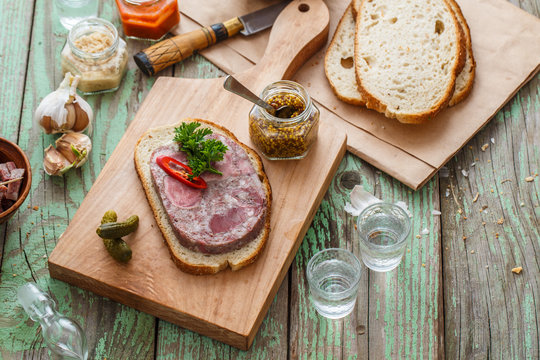 Headcheese sandwich on a cutting board, copy space