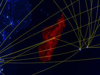 Madagascar from space on model of planet Earth at night with networks. Detailed planet surface with city lights.
