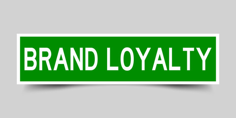 Square green color sticker with word brand loyalty on gray background
