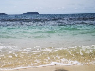 Beautiful wave breaks to the shore and create swash on the beach