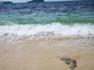 Beautiful wave breaks to the shore and create swash on the beach