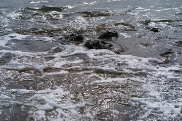 The stony coast of the Atlantic Ocean. Image of the Grand Canaria island surf  (Spain)