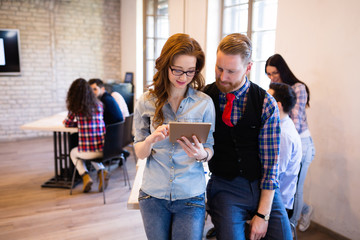 Young attractive architects discussing in modern office