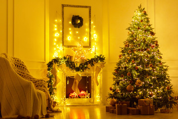 Christmas interior in the living room at evening in lights - fireplace, Christmas tree and chair