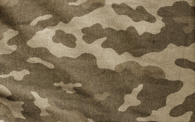 Old camouflage cloth in brown tone.
