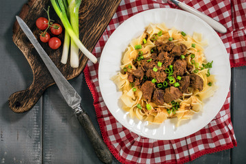 Stewed beef with tagliatelle pasta.